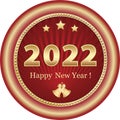 Happy New Year 2022. Christmas card with numbers 2022 in golden round frame on red radial background with stars and bells. Royalty Free Stock Photo